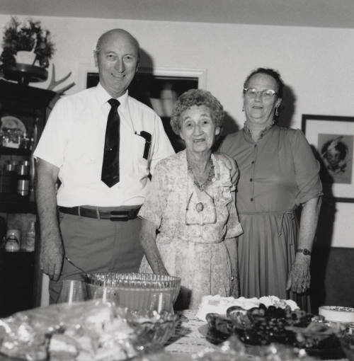 Unidentified Family standing by dinner table