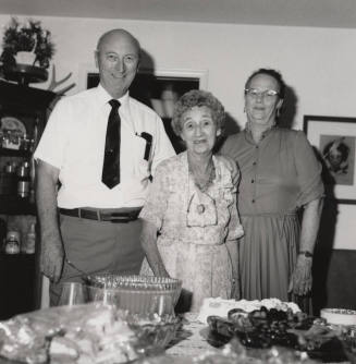 Unidentified Family standing by dinner table