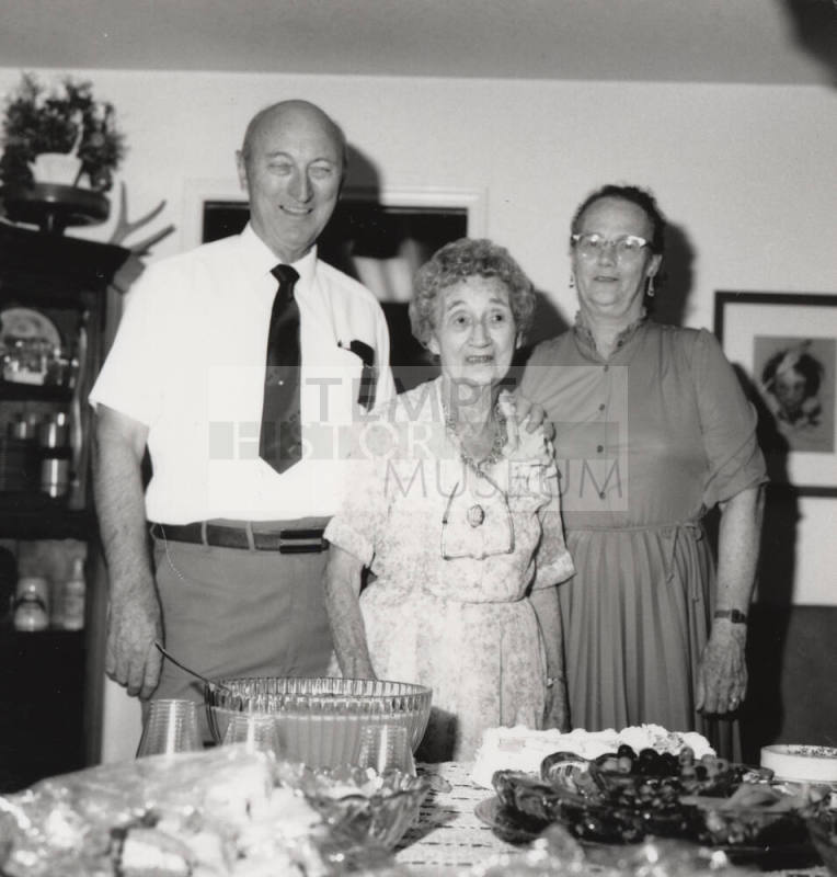 Unidentified Family standing by dinner table