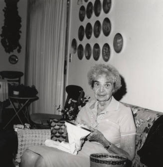 Rayma Neeb needlepoints in her living room
