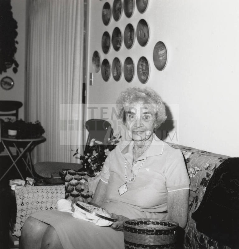 Rayma Neeb needlepoints in her living room