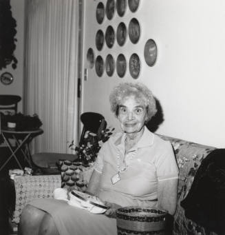 Rayma Neeb needlepoints in her living room