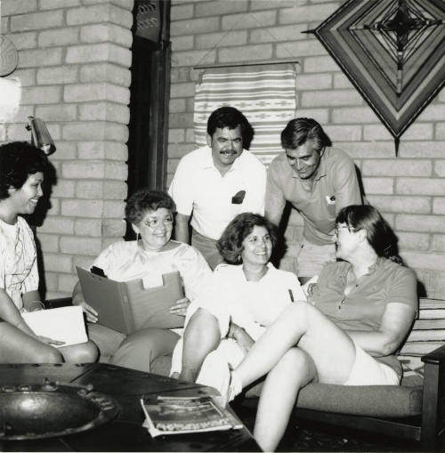 Unidentified group of 4 women & 3 men in discussion