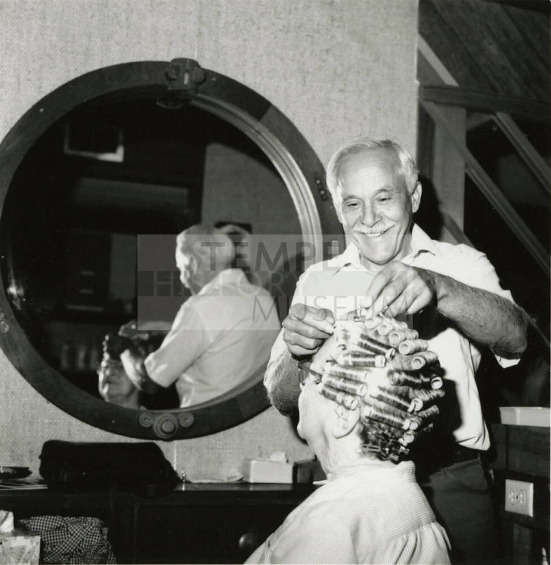 Unidentified man giving woman a permanent