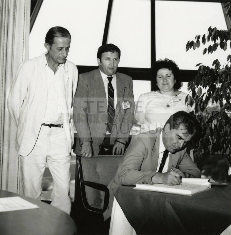 Signing the papers.