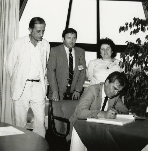 Signing the papers.