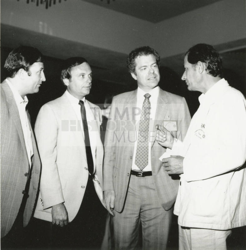 Group of men talking.