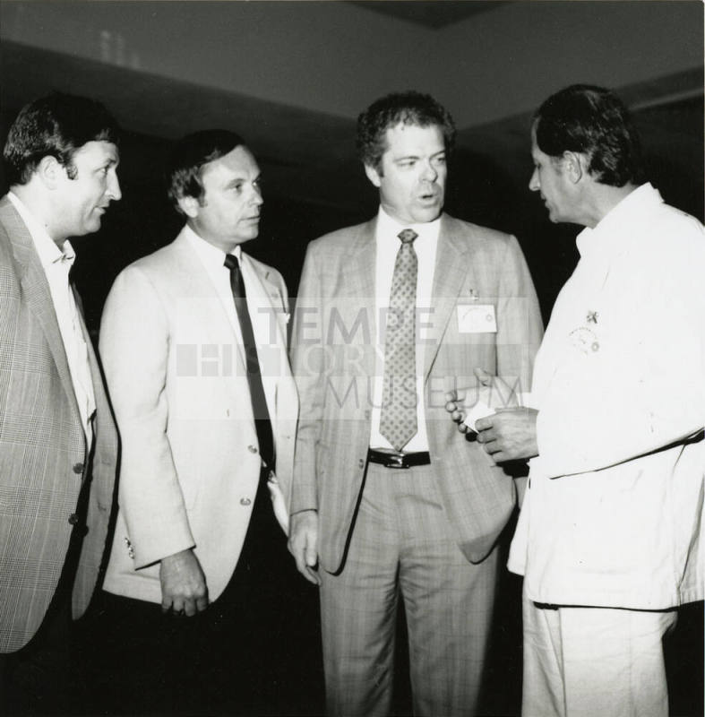 Group of men talking.