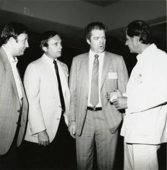 Group of men talking.