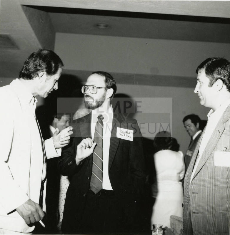 Group of men talking.