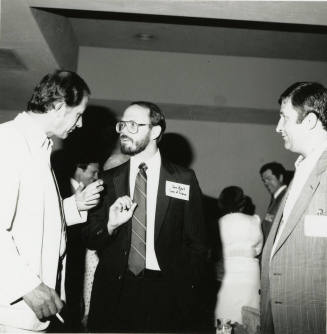 Group of men talking.