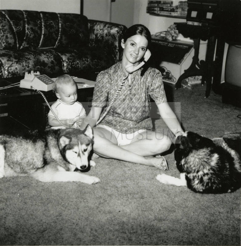 Woman sitting with family.
