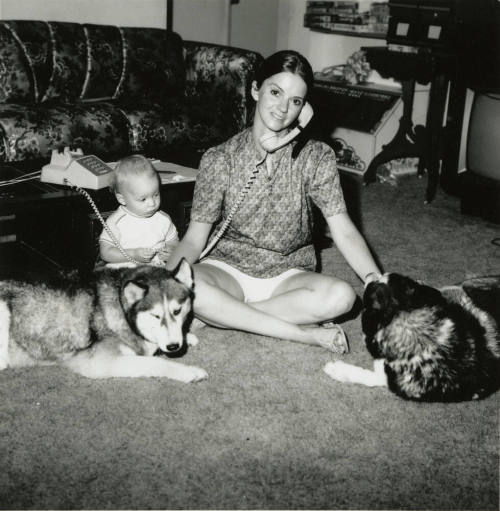Woman sitting with family.