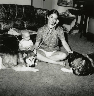 Woman sitting with family.