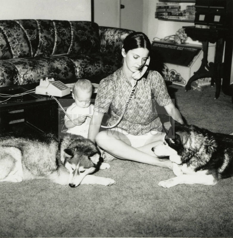 Woman sitting with family.