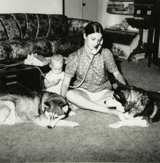 Woman sitting with family.