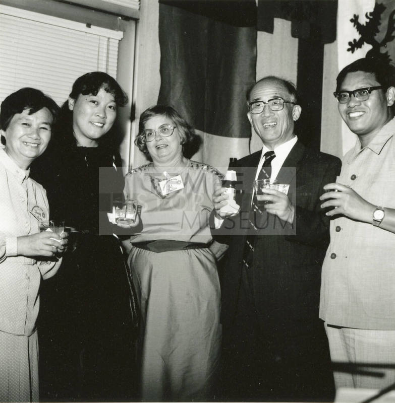 Group of people standing around.