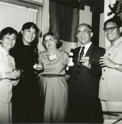 Group of people standing around.