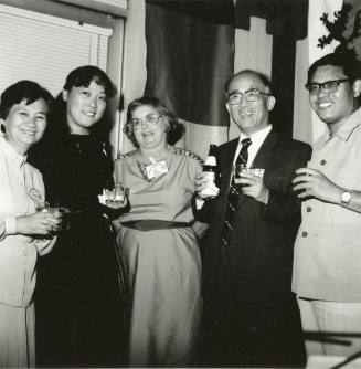 Group of people standing around.