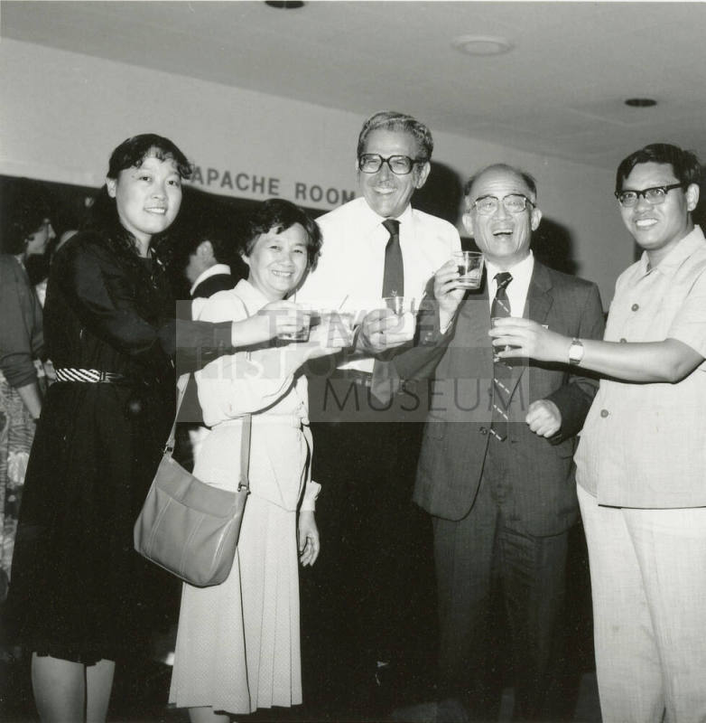 Group of people standing around.