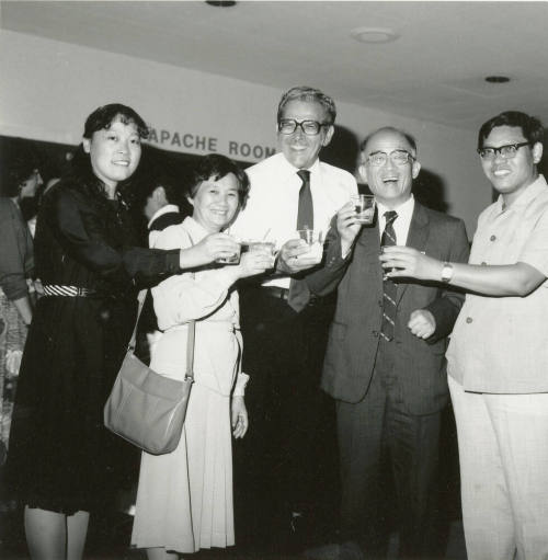 Group of people standing around.