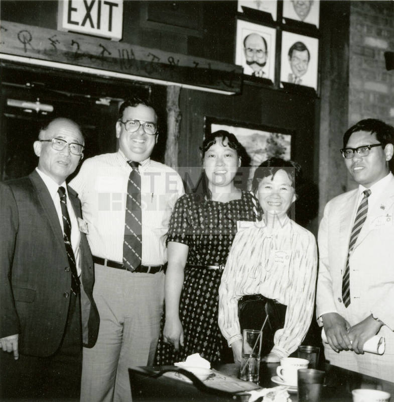 Group of people standing around.
