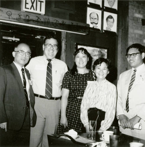 Group of people standing around.