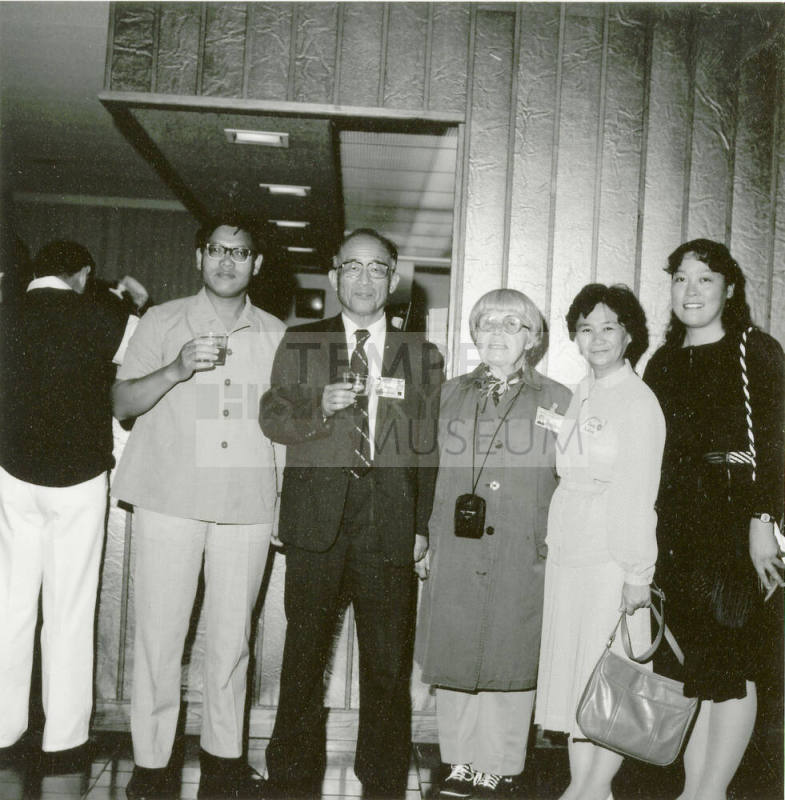 Group of people standing around.