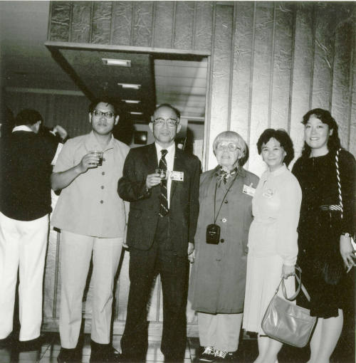 Group of people standing around.