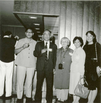 Group of people standing around.