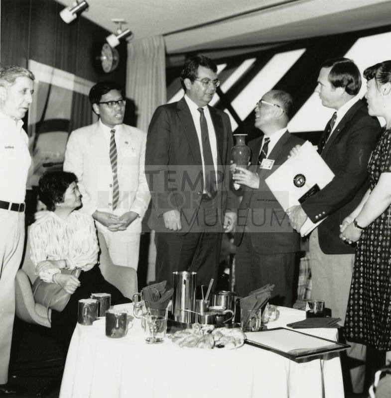 Group of people standing around.