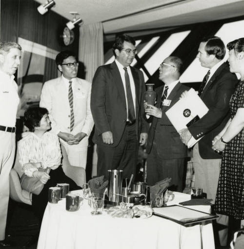 Group of people standing around.