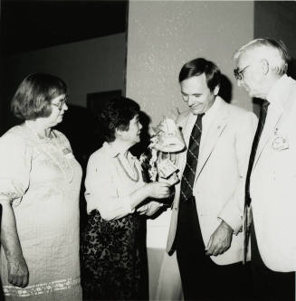Group of people standing around.