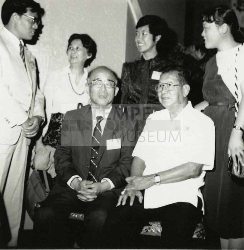Family members posing for a  camera.