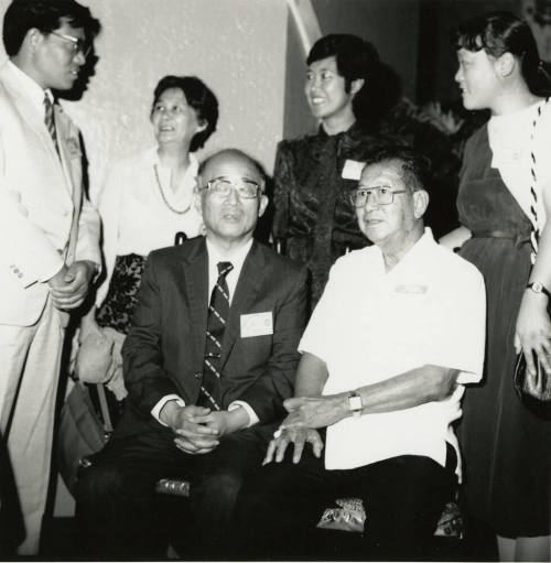 Family members posing for a  camera.