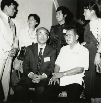 Family members posing for a  camera.