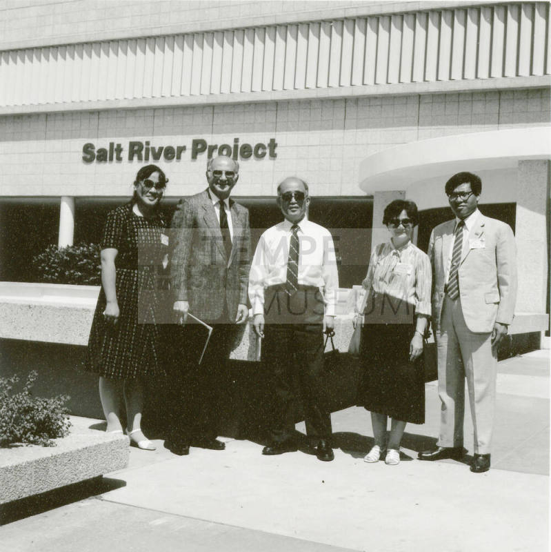 People standing taking a group photo.
