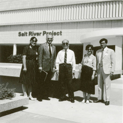 People standing taking a group photo.