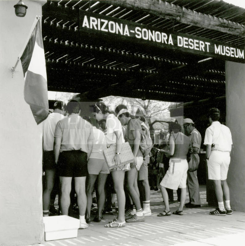 A group of people stand at the entry of  the Arizona-Sonora Desert Museum.
