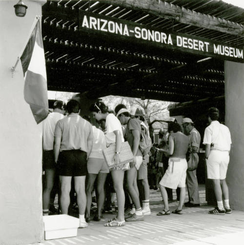 A group of people stand at the entry of  the Arizona-Sonora Desert Museum.