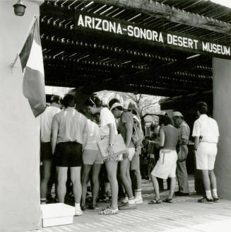 A group of people stand at the entry of  the Arizona-Sonora Desert Museum.
