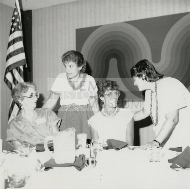 Four unidentified women at a banquet table.