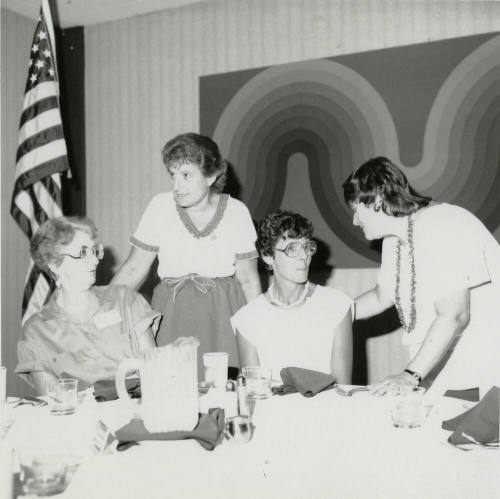 Four unidentified women at a banquet table.