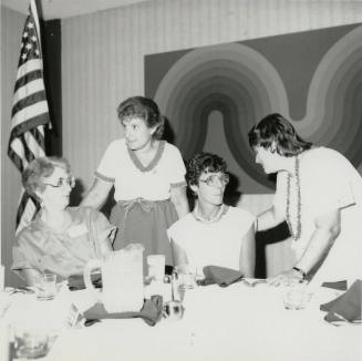 Four unidentified women at a banquet table.