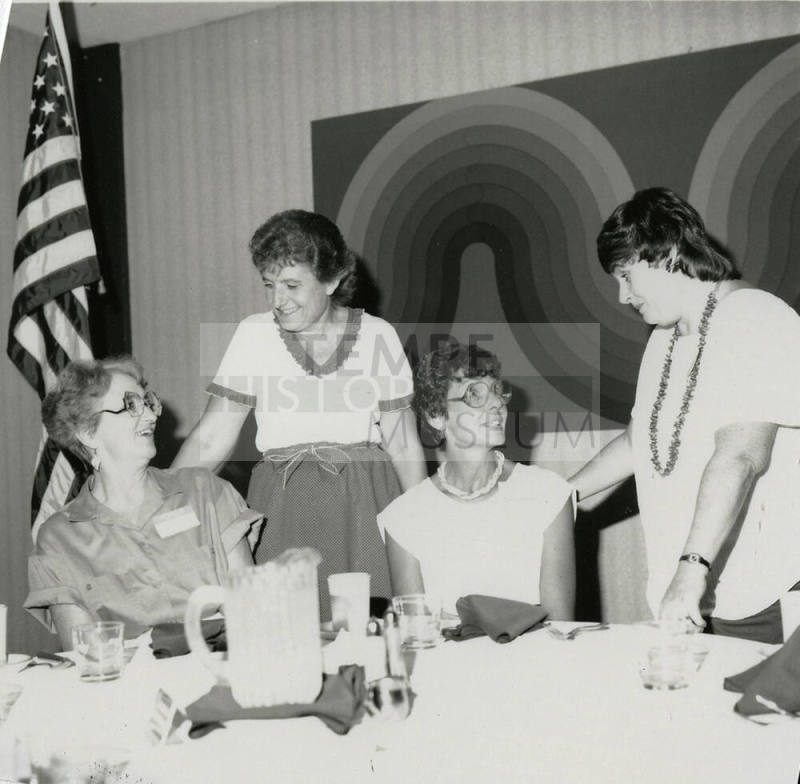 Four unidentified women at a banquet table.