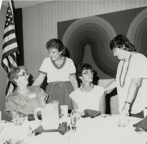 Four unidentified women at a banquet table.