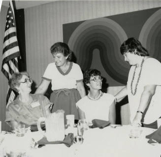Four unidentified women at a banquet table.