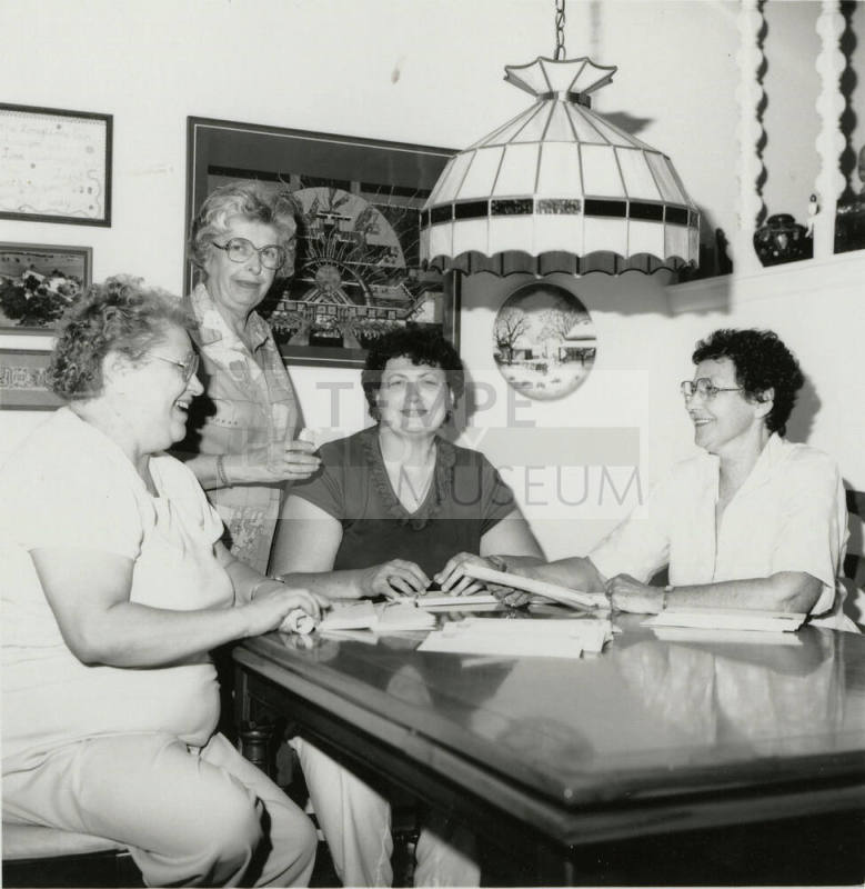 Four unidentified women at a table