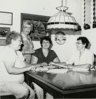 Four unidentified women at a table
