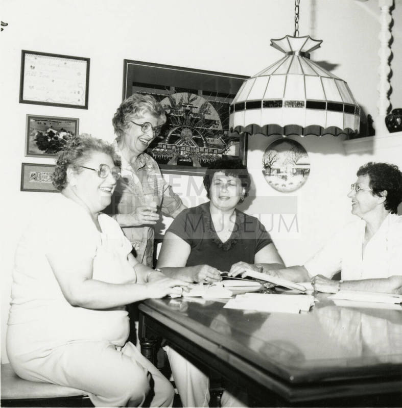 Four unidentified women at a table